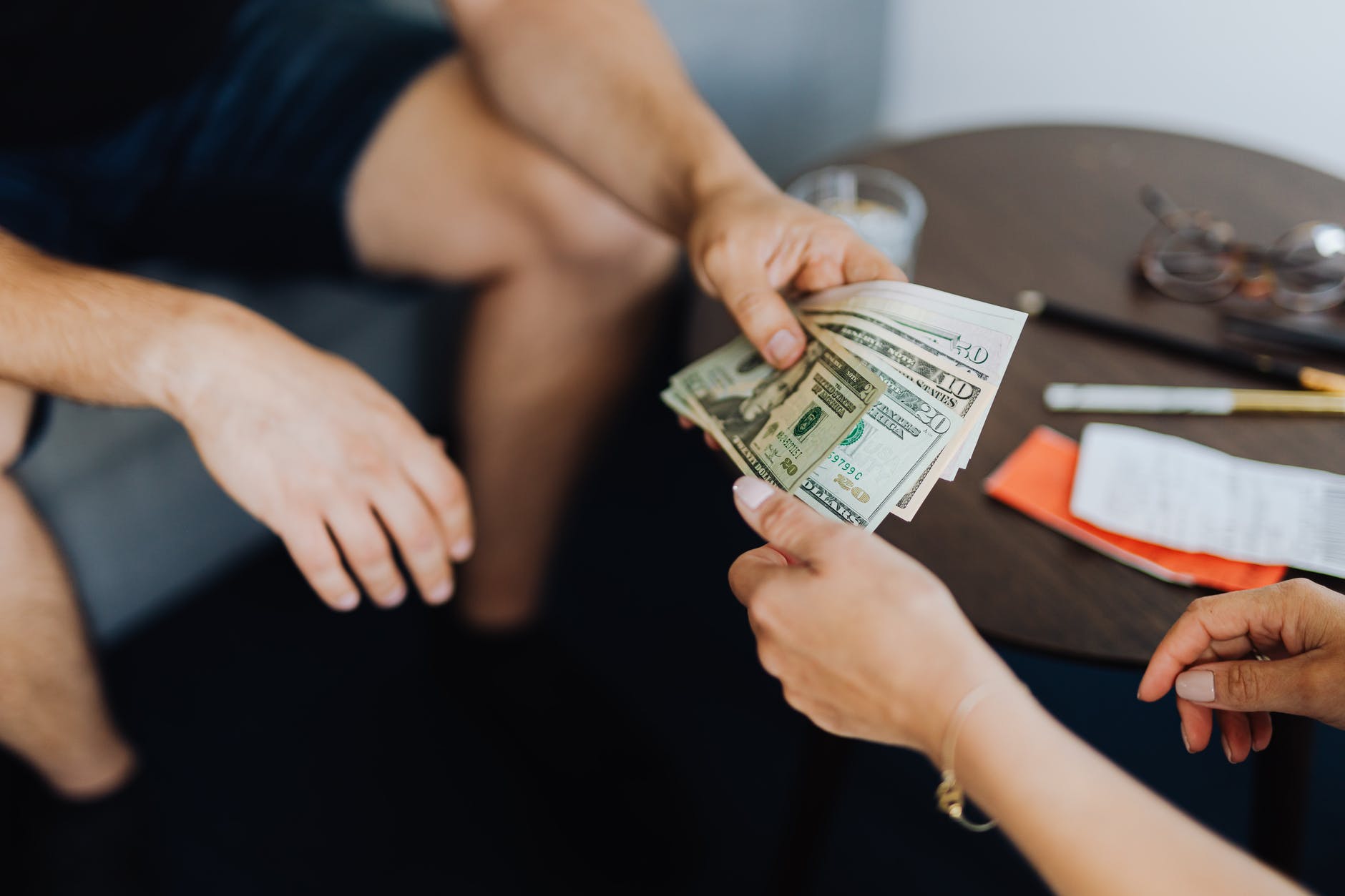 person giving money to another person